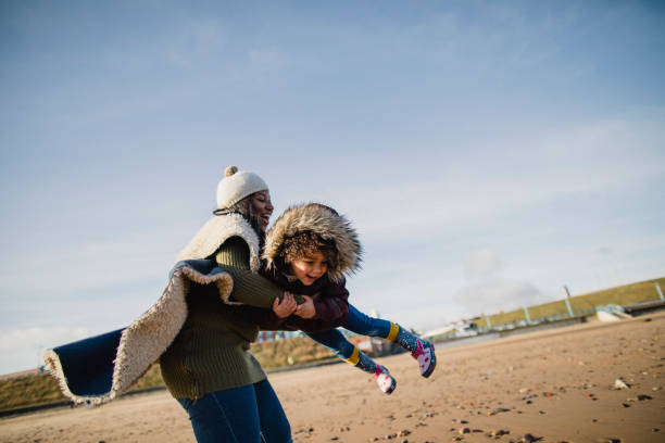 istock Mother And Daughter Playing On The Beach 1134477452