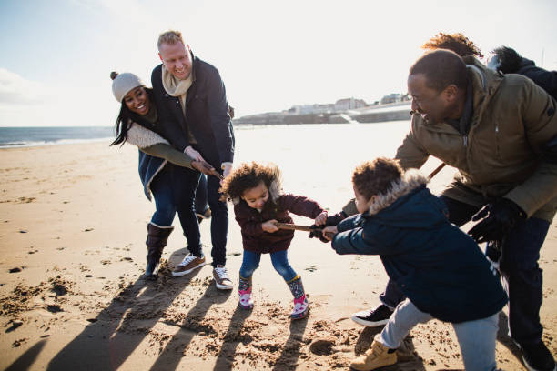 istock Three Generation Family Playing Tug-Of-War On The Beach 1134477575