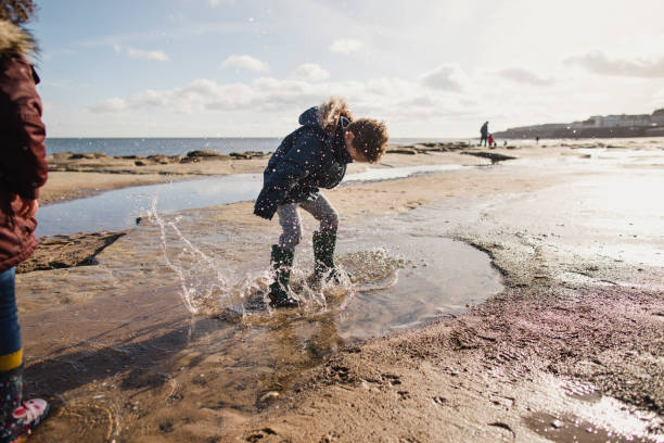 istock Little Boy Splashing In A Puddle 1134478394