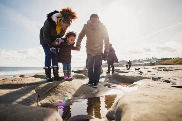 Three Generation Family Walking On The Beach