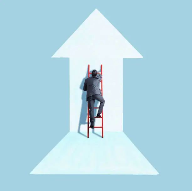 Photo of Businessman Climbing Ladder Following Direction of Arrow