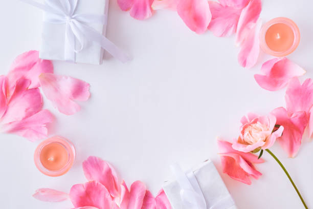 istock Flat lay composition with pink petals and gift boxes on a white background 1134482144