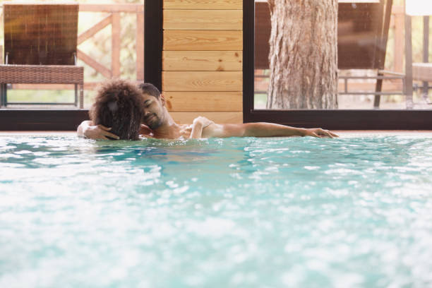 istock Affectionate couple relaxing in swimming pool 1134482793