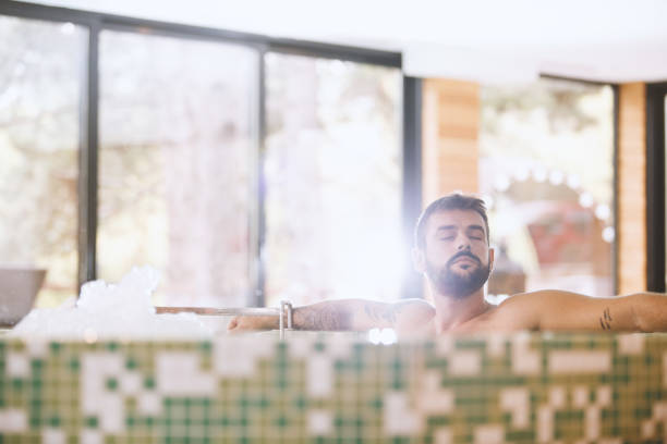 Man enjoying bubble bath in a hot tub