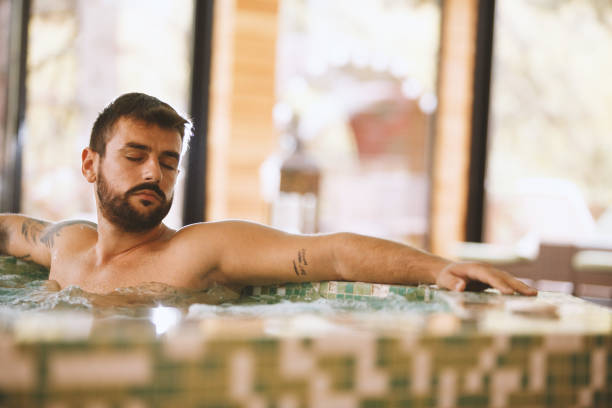 istock Man enjoying bubble bath in a hot tub 1134483007