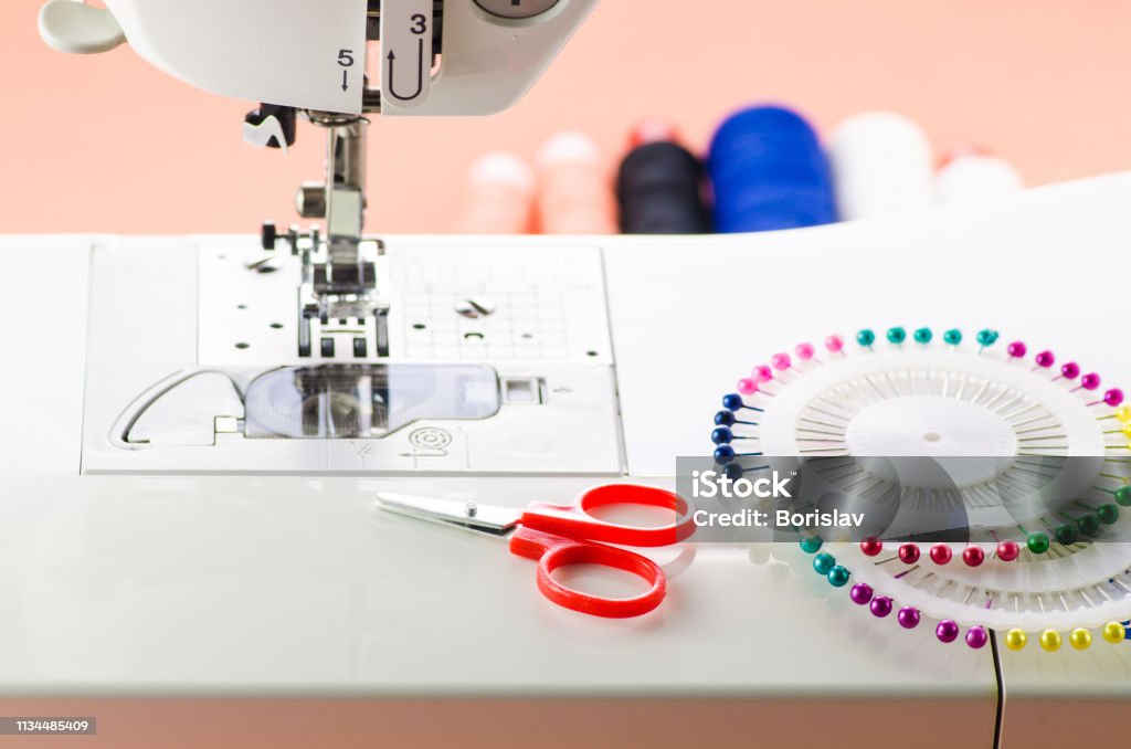 Sewing Accessories Are On A White Sewing Machine Scissors And English  Needles Stock Photo - Download Image Now - iStock