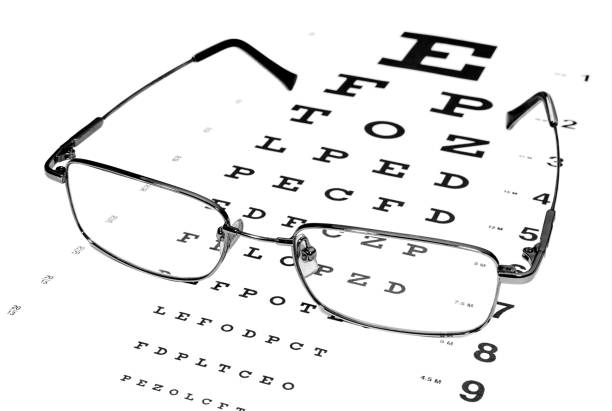 istock Glasses in a silver-rimmed on the Snellen eye chart 1134486595