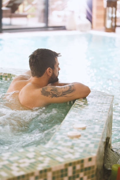 istock Tatooed man relaxing in a spa 1134486799