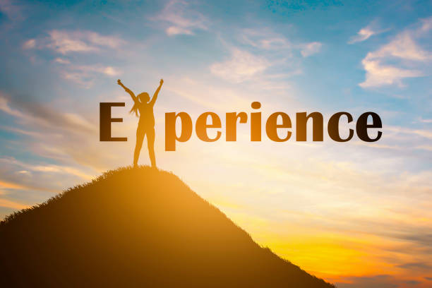 istock Silhouette of happy people and text EXPERIENCE in sunset background 1134486840