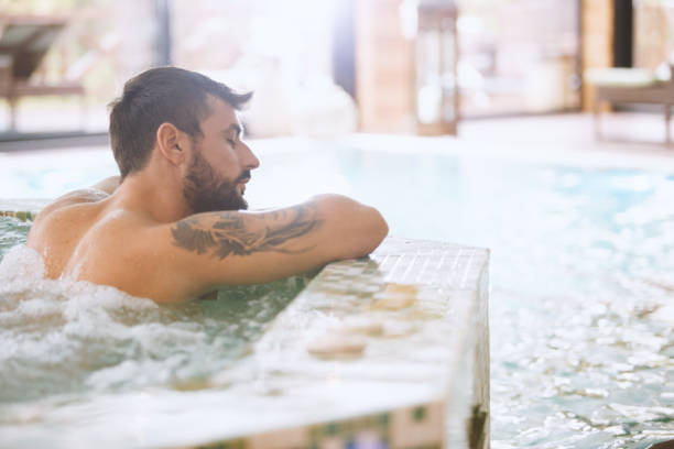 istock Tatooed man relaxing in a spa 1134487489