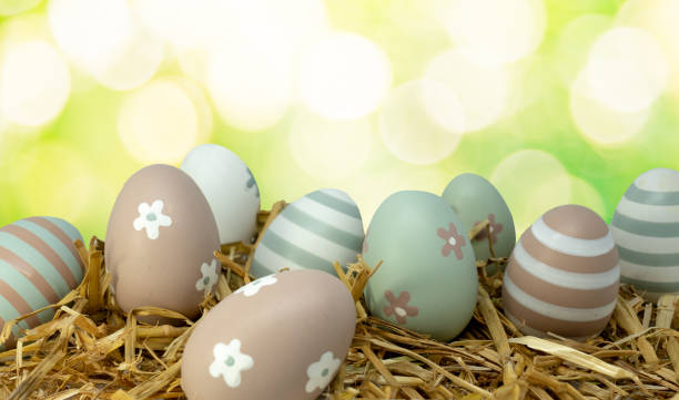 istock Easter painted eggs on straw isolated on colorful background 1134488476