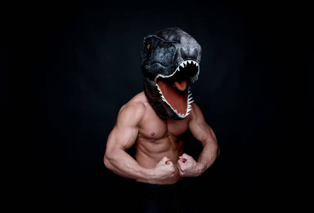 istock Sexy muscular man wearing a dinosaur mask 1134489348