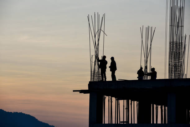 istock Construction industry - silhouette of a workers and concrete during sunset 1134489699