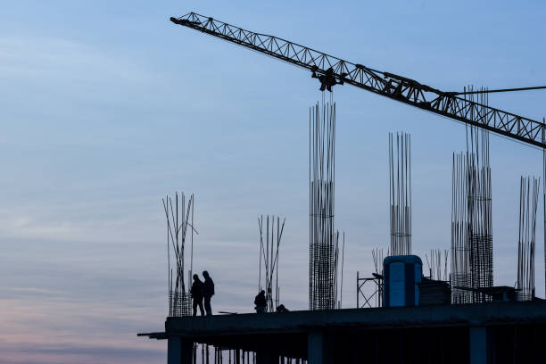 istock Construction industry - silhouette of a workers and concrete during sunset 1134489993