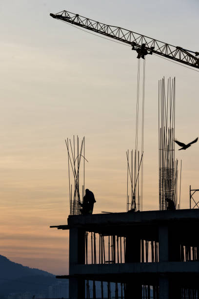 istock Construction industry - silhouette of a workers and concrete during sunset 1134490086