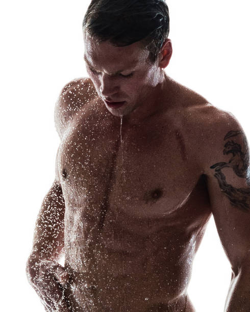 Sexy man taking a shower stock photo