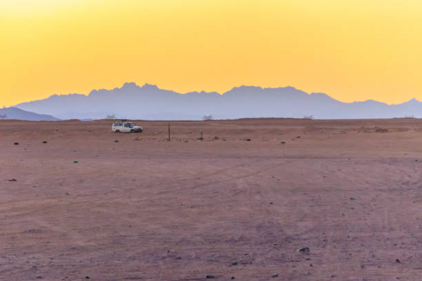istock Off road SUV car in Arabian desert at sunset 1134491552