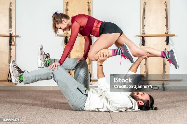 Young Healthy Yoga Fitness Acrobatic Couple Having Fun In The Gym Performing  And Practicing Funny Acrobat Poses Real People Training Workout Stock Photo  - Download Image Now - iStock