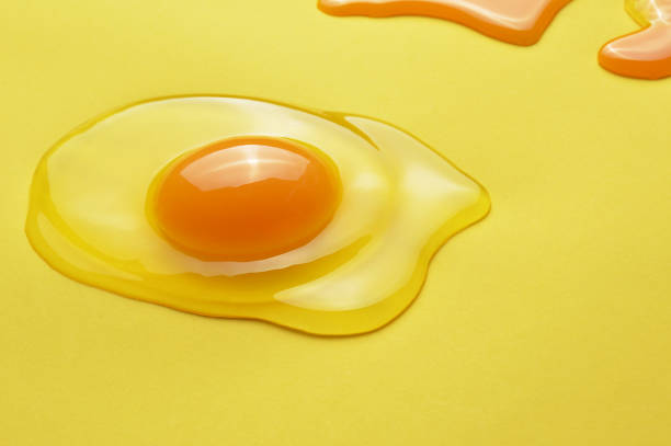 istock Raw egg yolk on the yellow background 1134494665