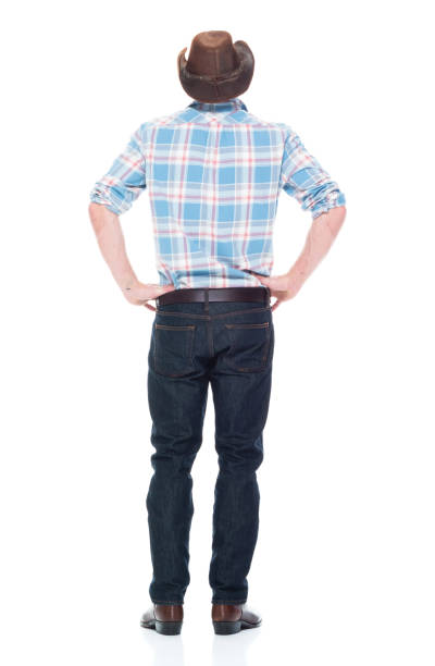 istock Handsome cowboy is standing with hands on hips 1134497920