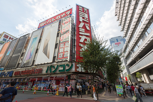 Tokyo, Japan - September 19, 2015 : People walk past the Yodobashi Camera in Shinjuku, Tokyo, Japan. Yodobashi Camera is a shopping mall sells home electronics, appliances and multimedia goods, as well as digital cameras, camcorders, games, hobbies and watches.