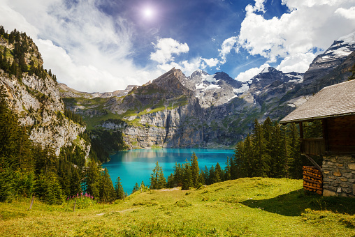 Great panorama of the azure pond Oeschinensee. Popular tourist attraction. Picturesque and gorgeous scene. Location Swiss alps, Kandersteg, Bernese Oberland, Europe. Artistic picture. Beauty world.