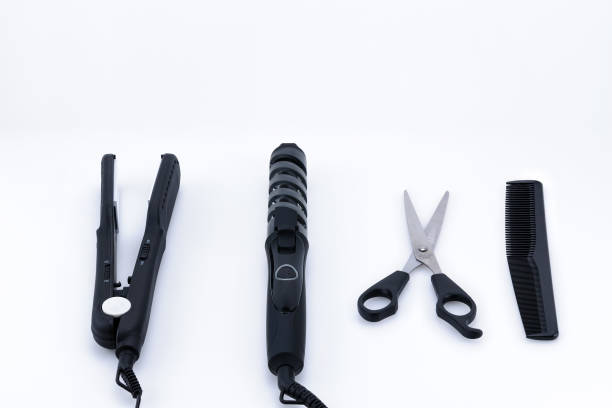 Grey hair iron with accessory on the white background with copy space.