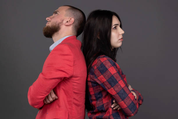 istock young angry couple standing back to back. offended. disappointed spouses 1134503839