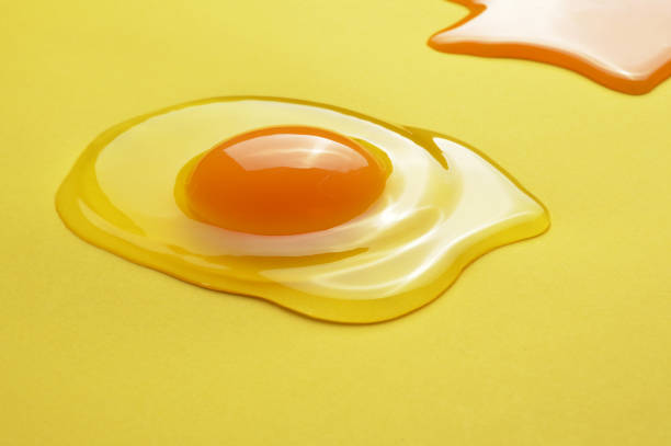 istock Raw egg yolk on the yellow background 1134505140