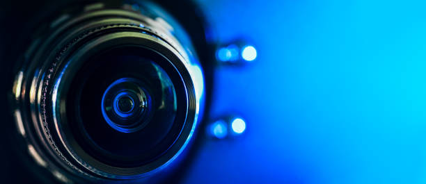 istock The camera lens and blue backlighting . Horizontal photography. Banner 1134505572