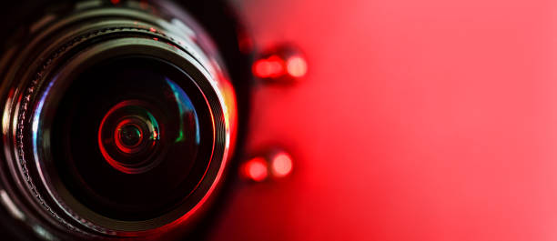 istock Camera lens and red backlight . Horizontal photography. Banner 1134505641