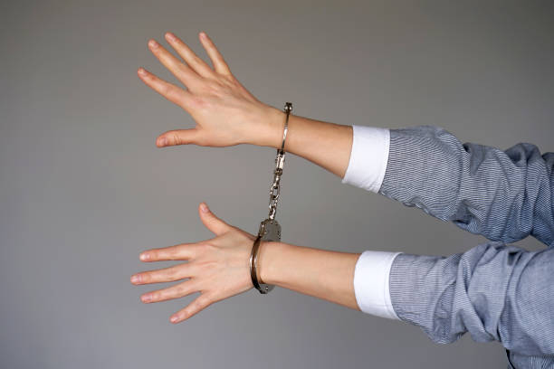 istock Criminal hands locked in handcuffs. 1134506670