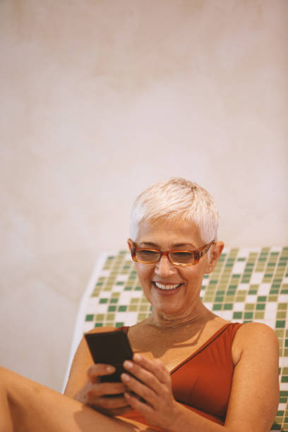 istock Mature woman using phone at the spa 1134506911