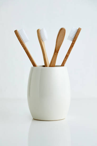 istock Four bamboo toothbrushes in gray glass 1134508693