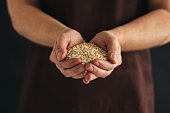 A man with a handful of oat flakes