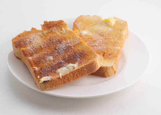 buttered toast on plate stock photo