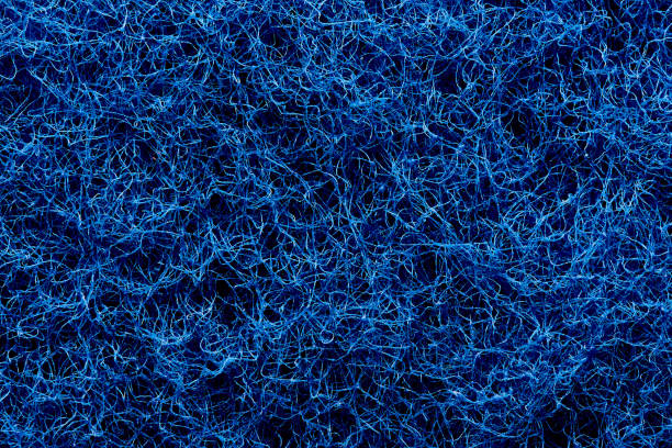 the texture of the surface of interwoven blue threads of abrasive synthetic fiber. - felt blue textured textile imagens e fotografias de stock