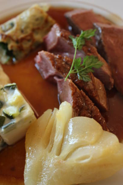 istock Roasted duck breast in sauce served with various garnishes 1134510240
