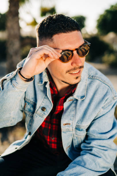 istock Attractive young man with sunglasses and denim jacket 1134512659