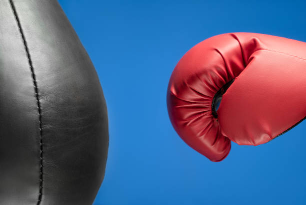 istock Boxing glove and punching bag. Blue background 1134517477