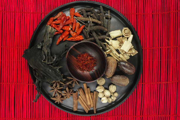 istock Various spices in black round bowl on red bamboo mat 1134519335
