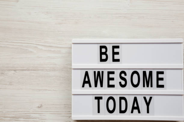 istock 'Be awesome today' word on modern board over white wooden surface, from above. Overhead, top view. Copy space. 1134520005