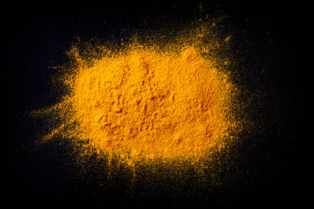 istock Curcuma turmeric spice powder on black background 1134521846