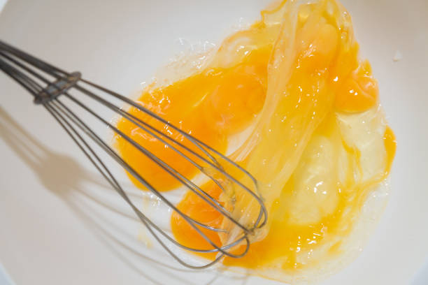 istock Whipping chicken eggs with a metal whisk in a mixing bowl 1134531054