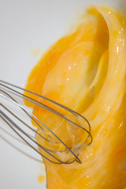 istock Whipping chicken eggs with a metal whisk in a mixing bowl 1134531072