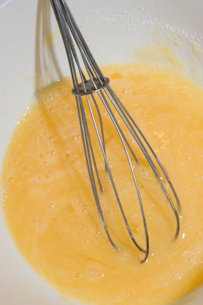 istock Sugar is mixed with beaten egg for dessert 1134531079