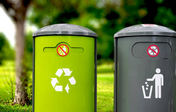istock Green Recycle and  a gary trash bins on focus with a blurred background 1134531483