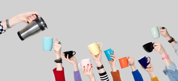 istock Many different arms raised up holding coffee cup 1134531539