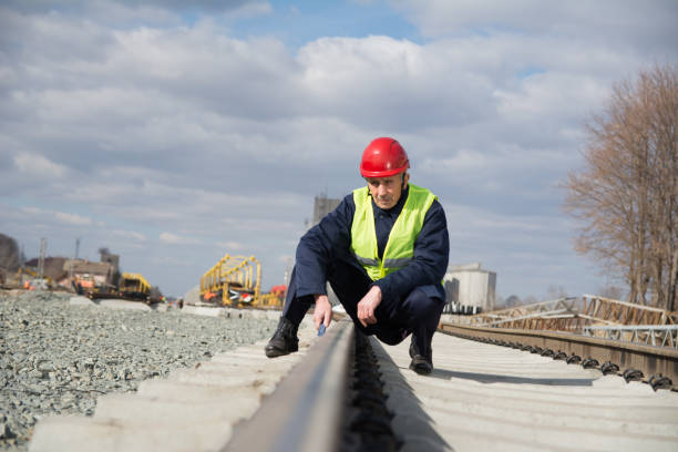 istock Railroad worker repairing train tracks 1134533221