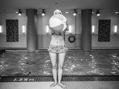 Young Asian woman having fun at the indoor swimming pool.